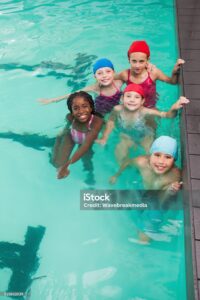 Cute little kids in the swimming pool at the leisure center
