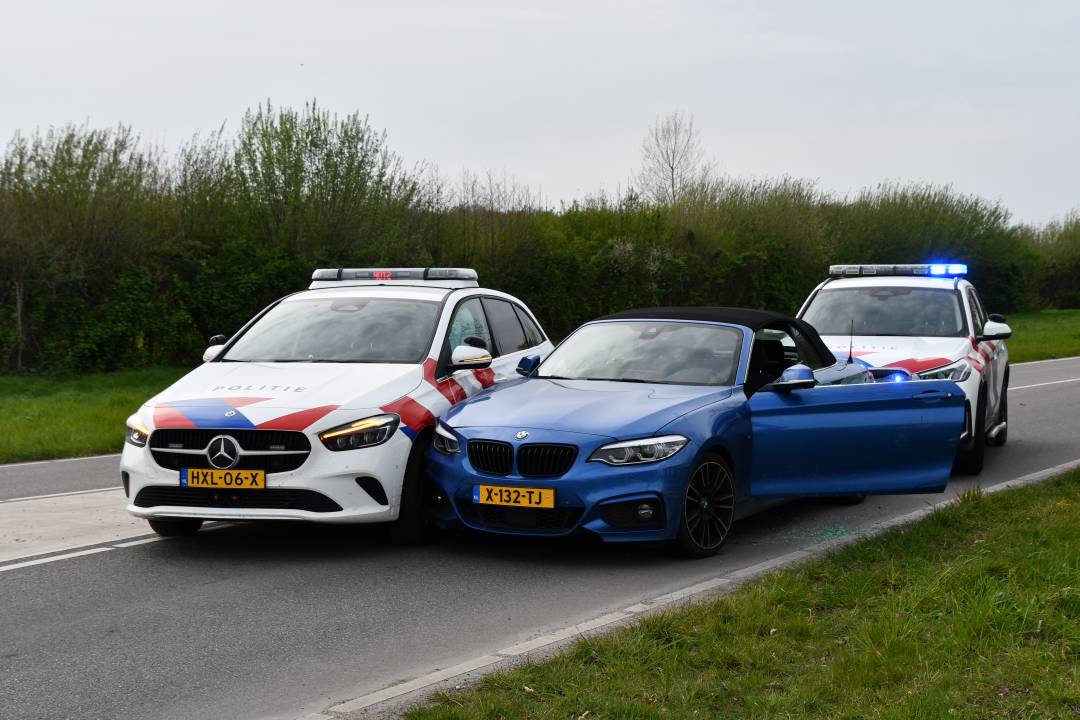 De auto rijdt tegen twee politiewagens op